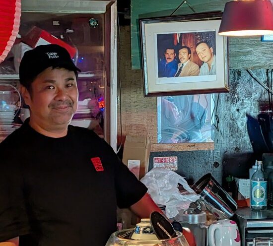 Friendly member of staff behind the counter at a gay bar in Tokyo’s Shinjuku Ni-chome district