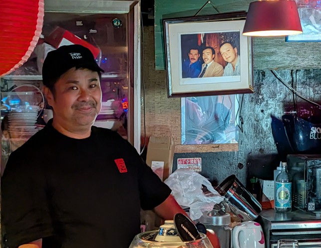 Friendly member of staff behind the counter at a gay bar in Tokyo’s Shinjuku Ni-chome district