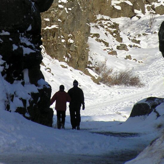 Thingvellir National Park Winter couple hiking on ice